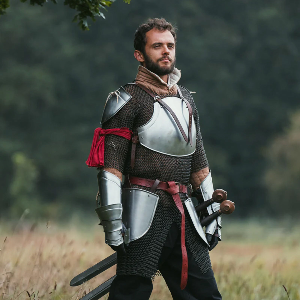 How to Care for Your LARP Gear: cosplaying with armored outfit in a scenic field.