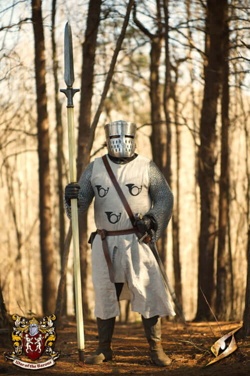Knight in armor wielding a spear in a forest setting, showcasing the power of Spears in historical battles.