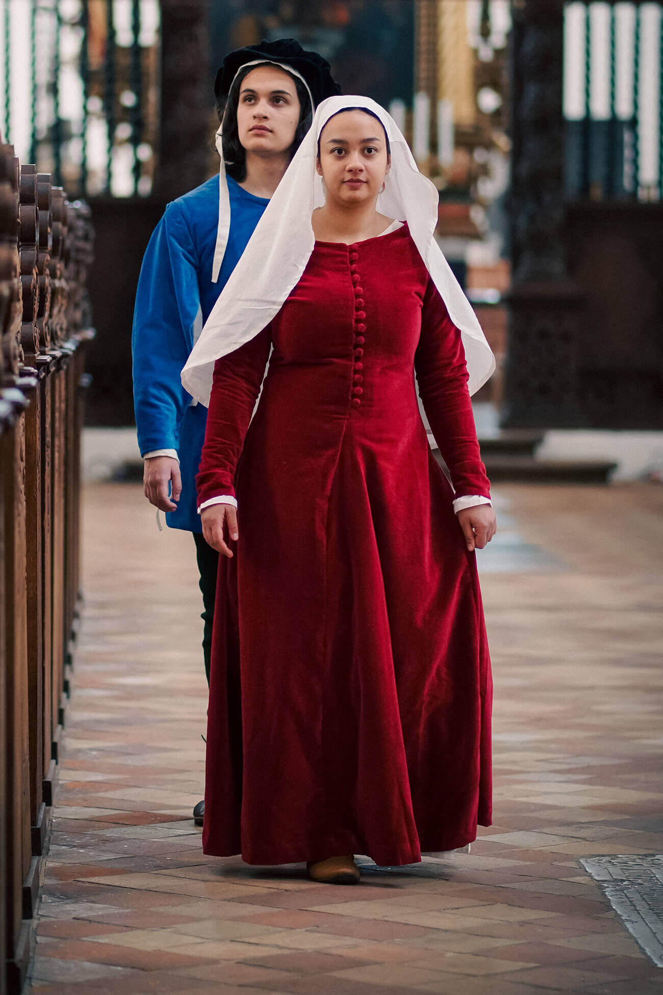 A woman and a man wearing late medieval clothing