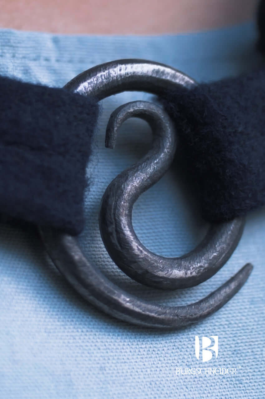 Brooch Spiral Brooch Lukka fastening on a dark fabric with a spiral design, perfect for securing cloaks.