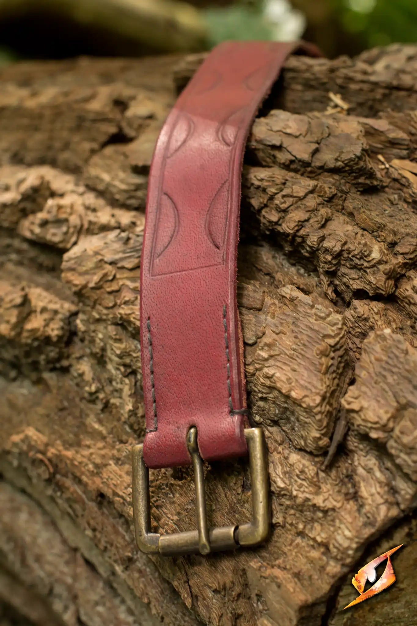 Aruthian Belt showcasing craftsmanship with detailed stitching and a vintage buckle on textured wood.