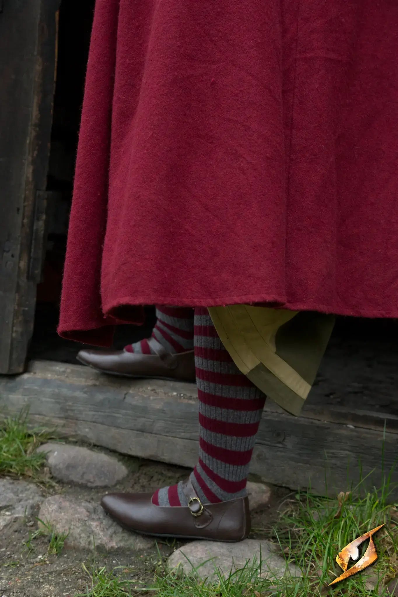 Shoes Astrid worn with striped socks, showcasing classic style and comfort on cobblestone streets.