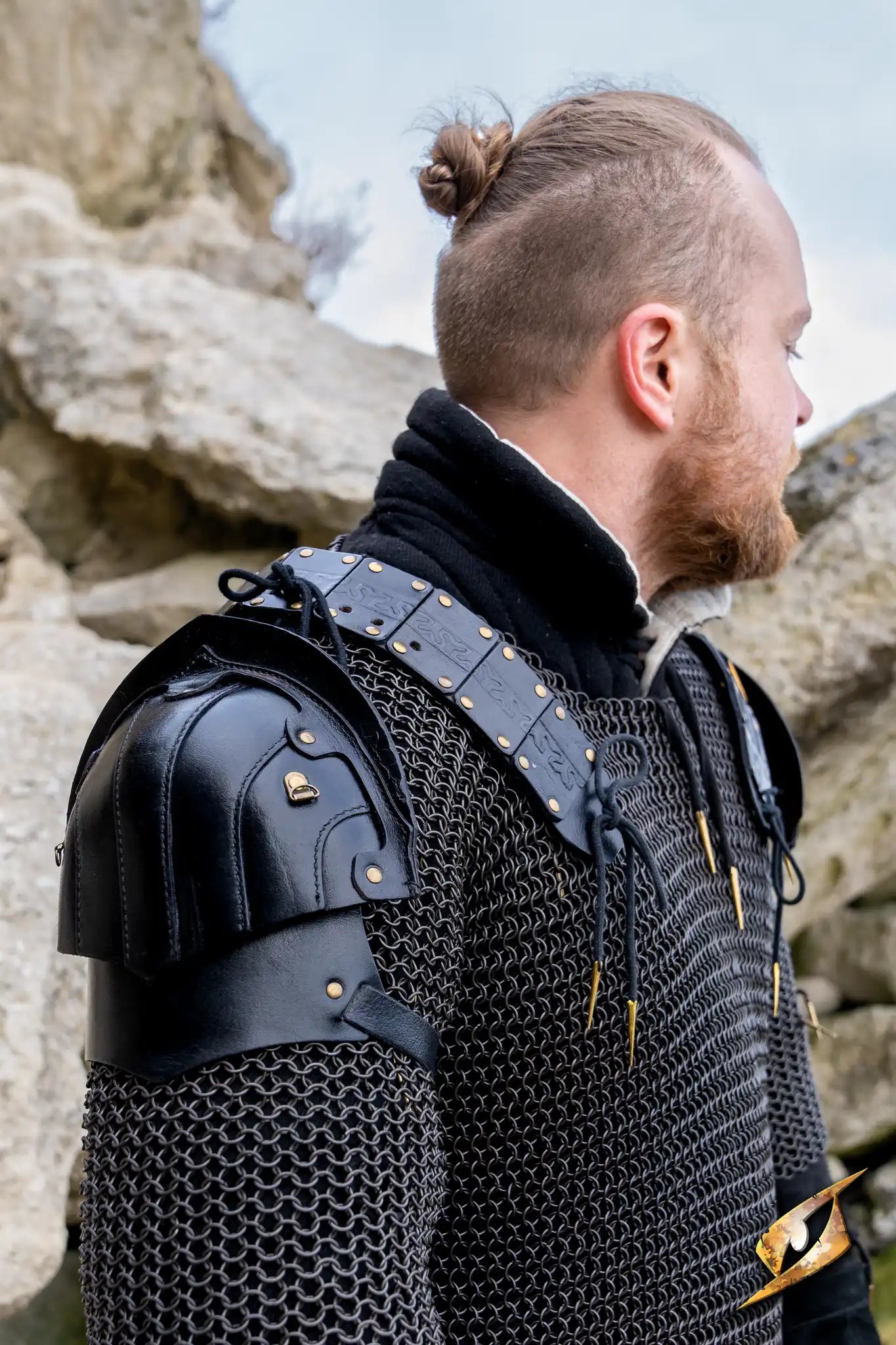 Woodsman Shoulder Set displayed on a warrior in chainmail, showcasing sleek black leather armor and detailed craftsmanship.