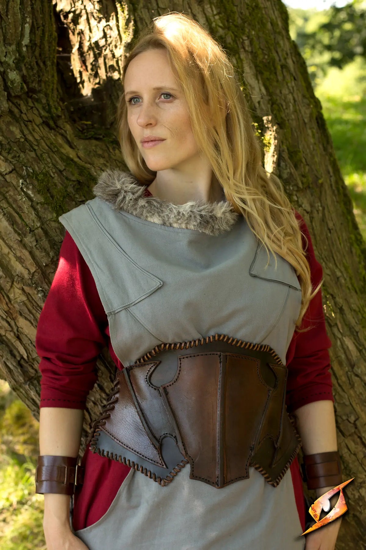 A model in a Dark Elf Corset stands in nature, showcasing the unique elven design and craftsmanship of the outfit.