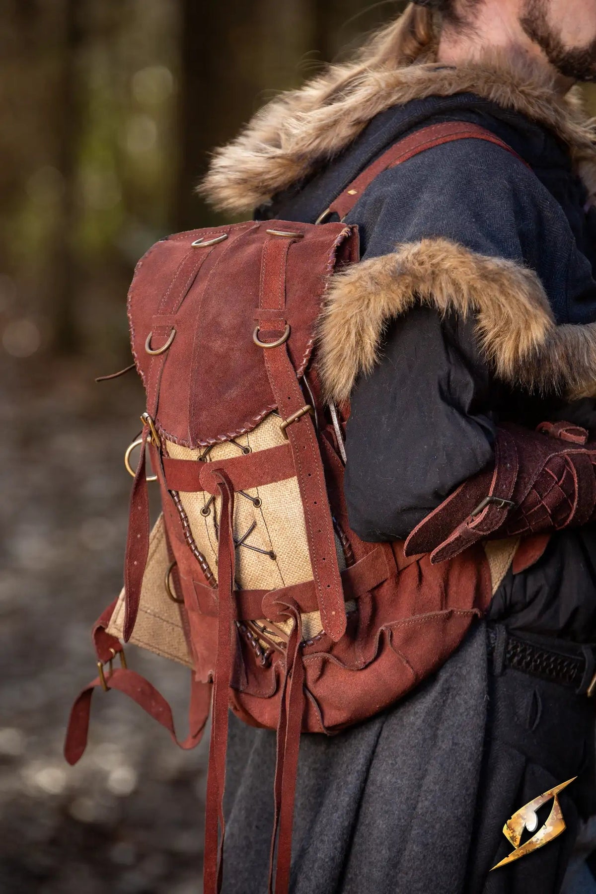 Adventurer Backpack - Suede worn by a traveler in a forest, showcasing its rugged design and functionality.