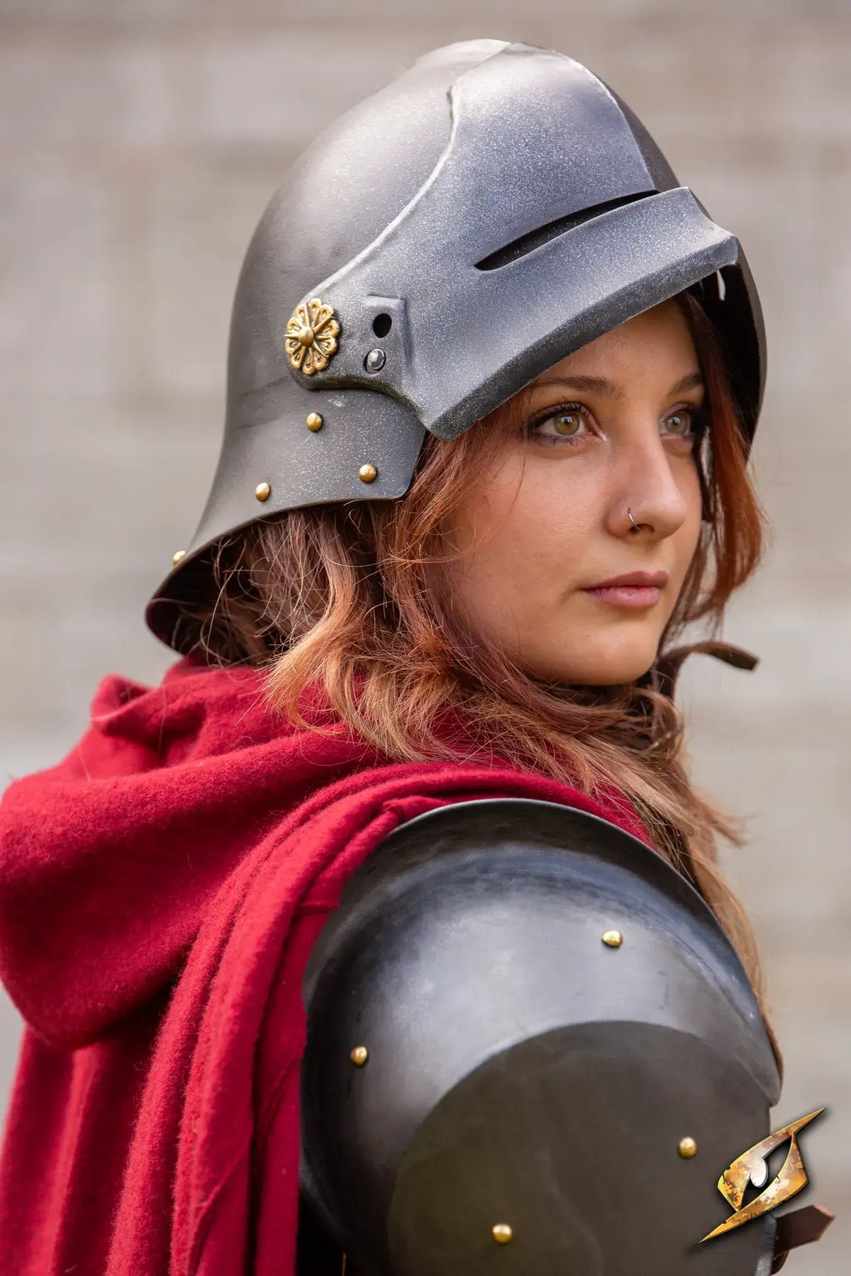 Woman wearing a Renegade Helmet, with red cloak and armor, portraying a soldier's spirit and resilience.