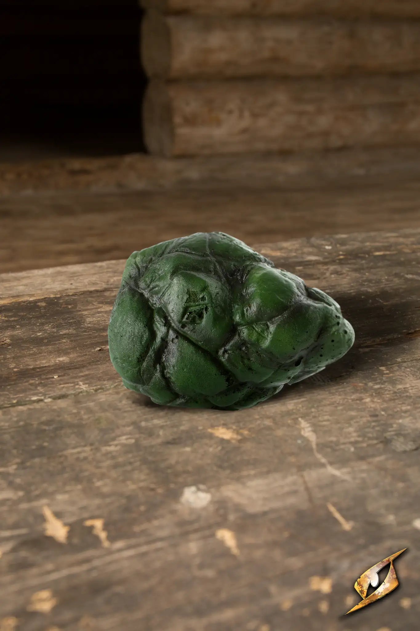 Stone decorative prop for warlocks featuring a green Bloodstone on a wooden surface.