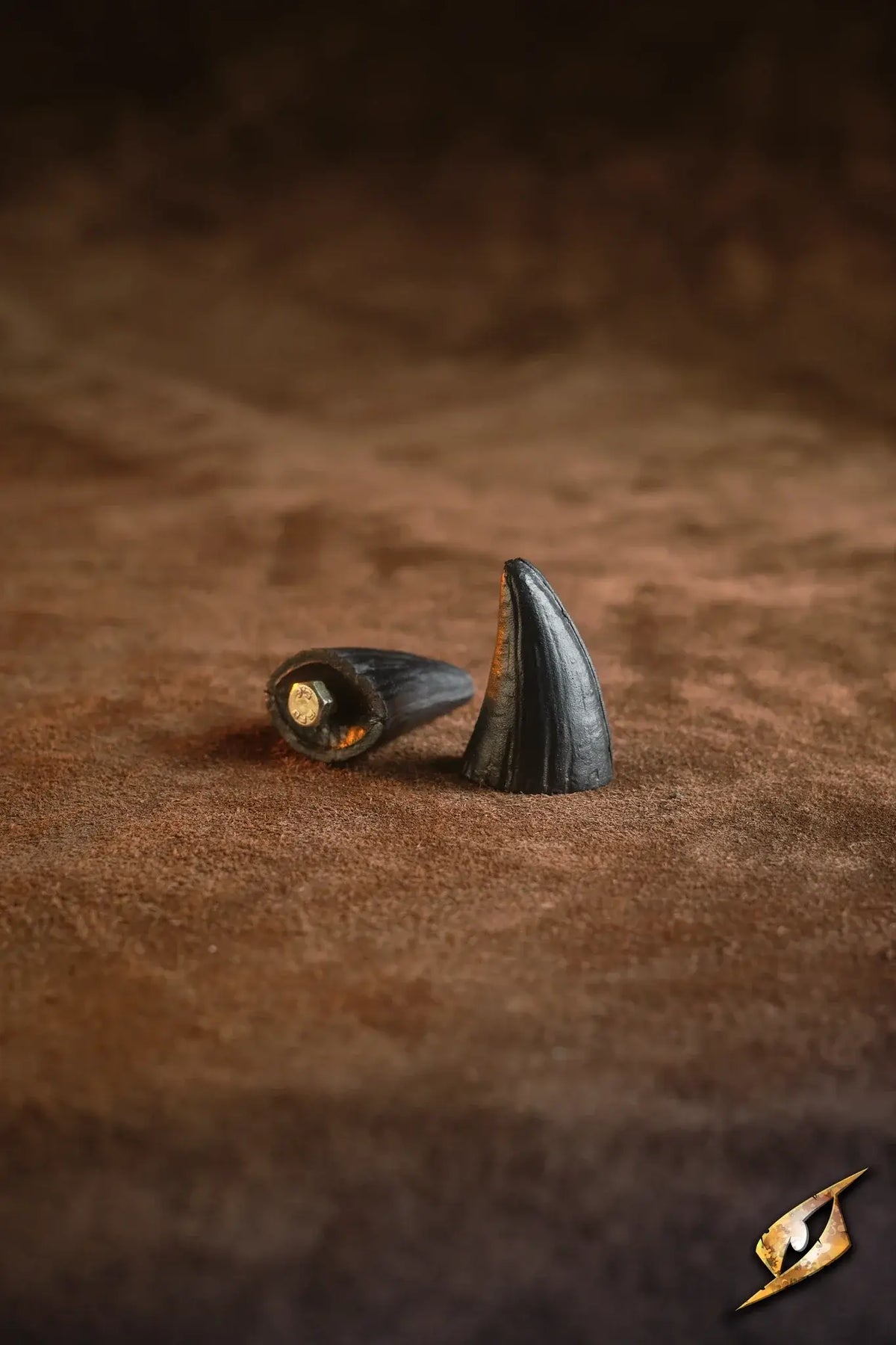 Mountable Demon Horns displayed on a brown surface, featuring a pair of stylish, black spikes for armor decoration.