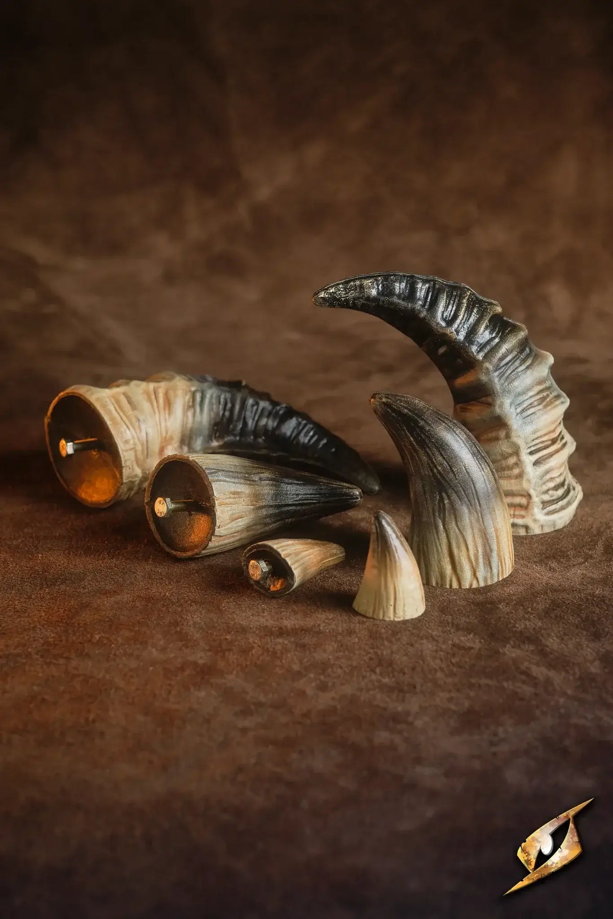 Mountable Demon Horns displayed on a brown fabric backdrop, perfect for enhancing villainous armor.