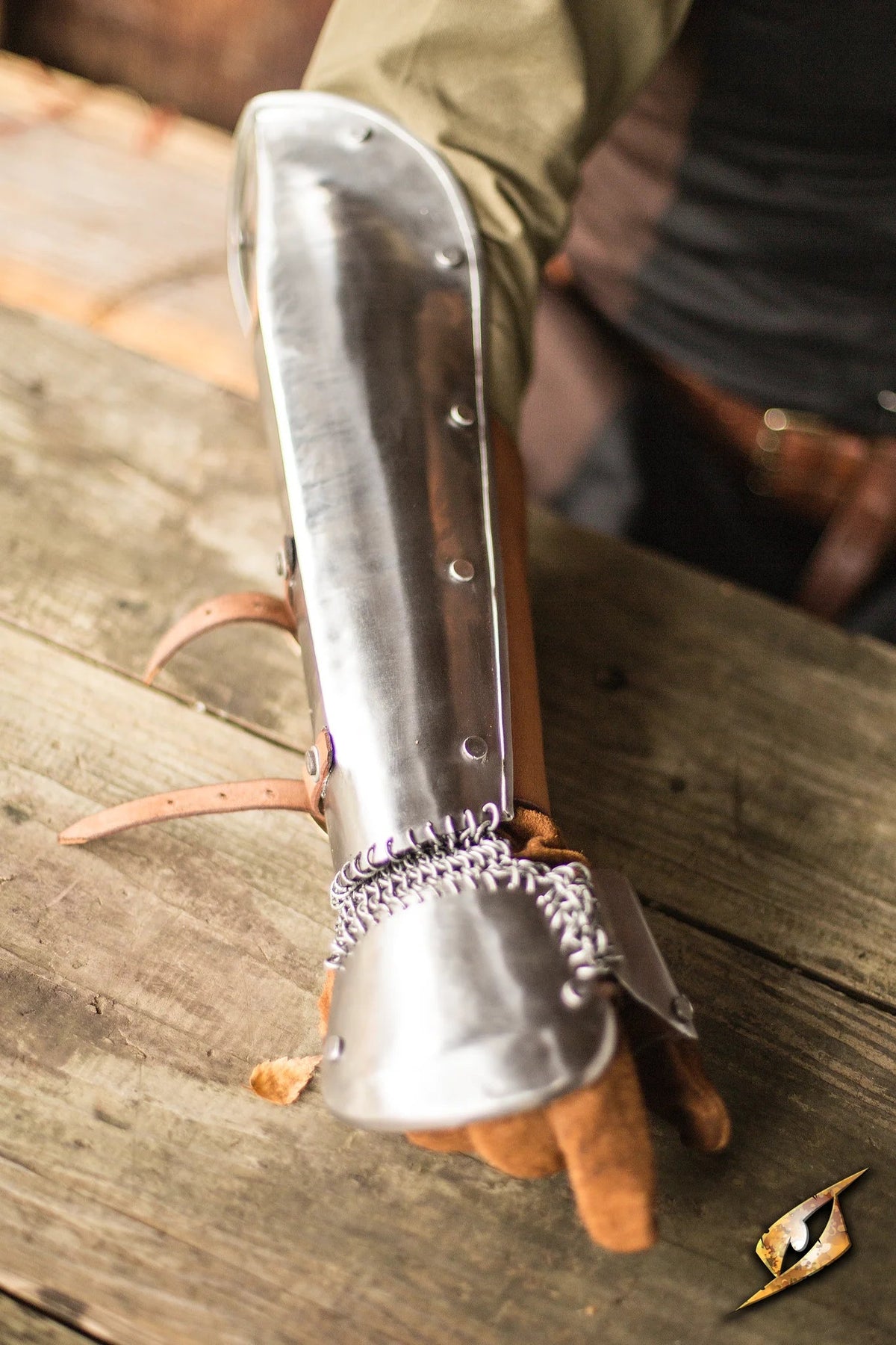 Polished Steel Bazuband shown on arm, combining elegance and protection for forearms in historical reenactments.