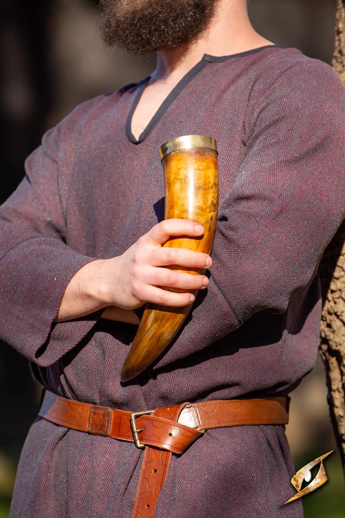 Warrior drinking horn 0,5 L held by a person in a medieval outfit, showcasing its ornate design and craftsmanship.