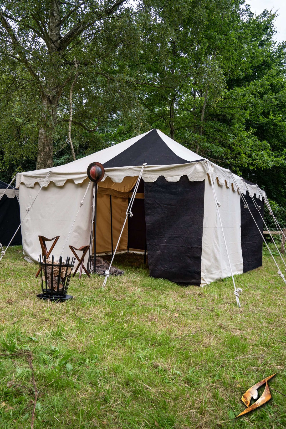 Marquee Tent - 4x4m set up in a grassy field with a mix of black and white fabric.