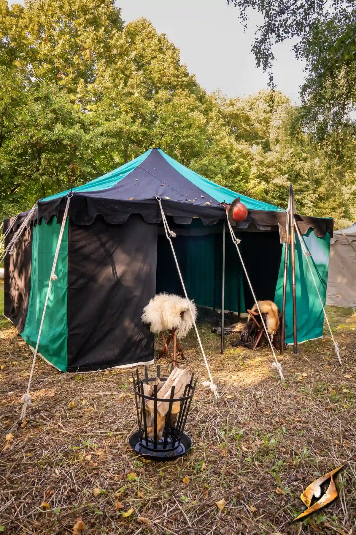 Marquee Tent - 4x4m with black and green fabric, surrounded by trees, featuring goats outside.