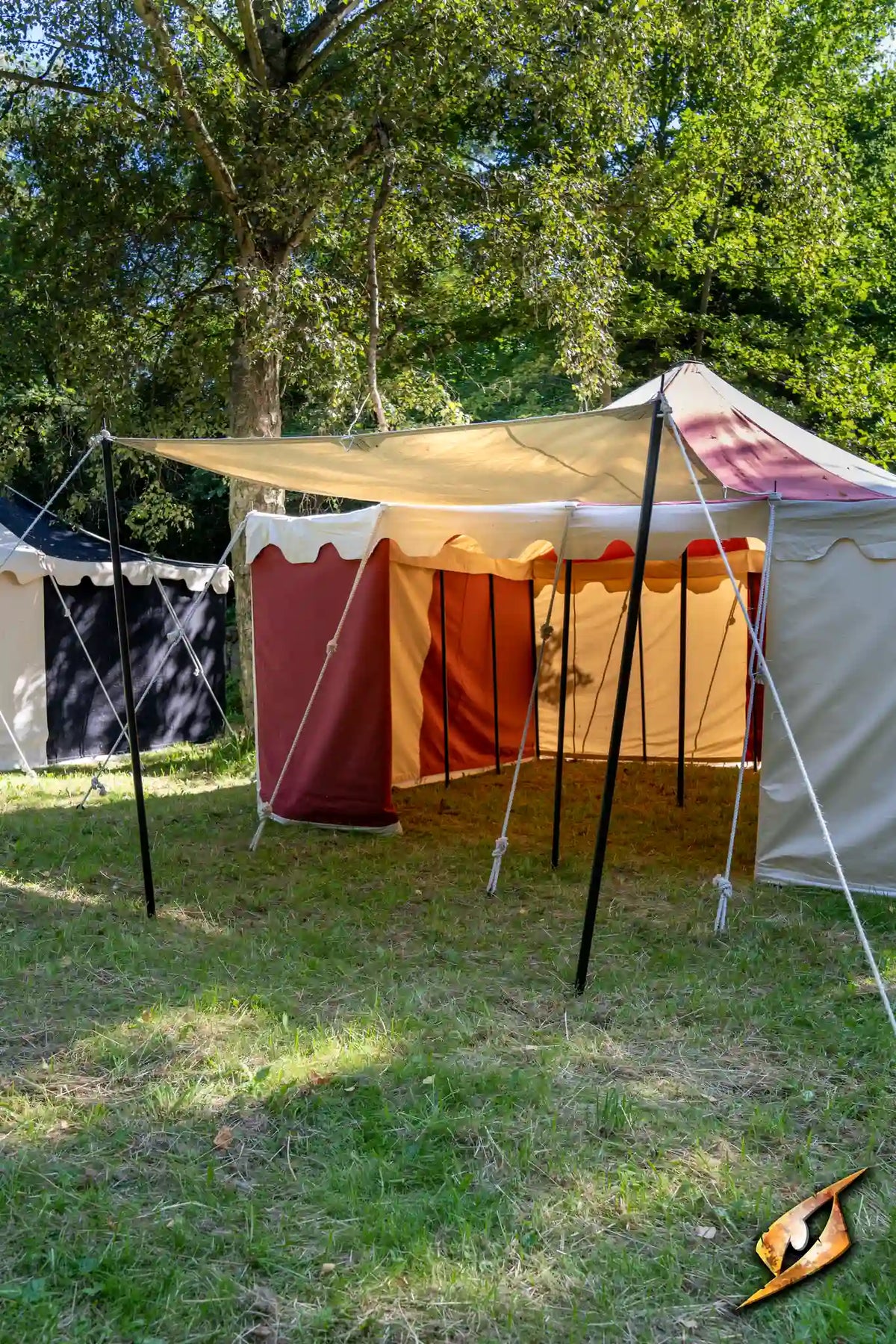 Epic Armoury Tarpaulin set up as a canopy in a camping area with tents.