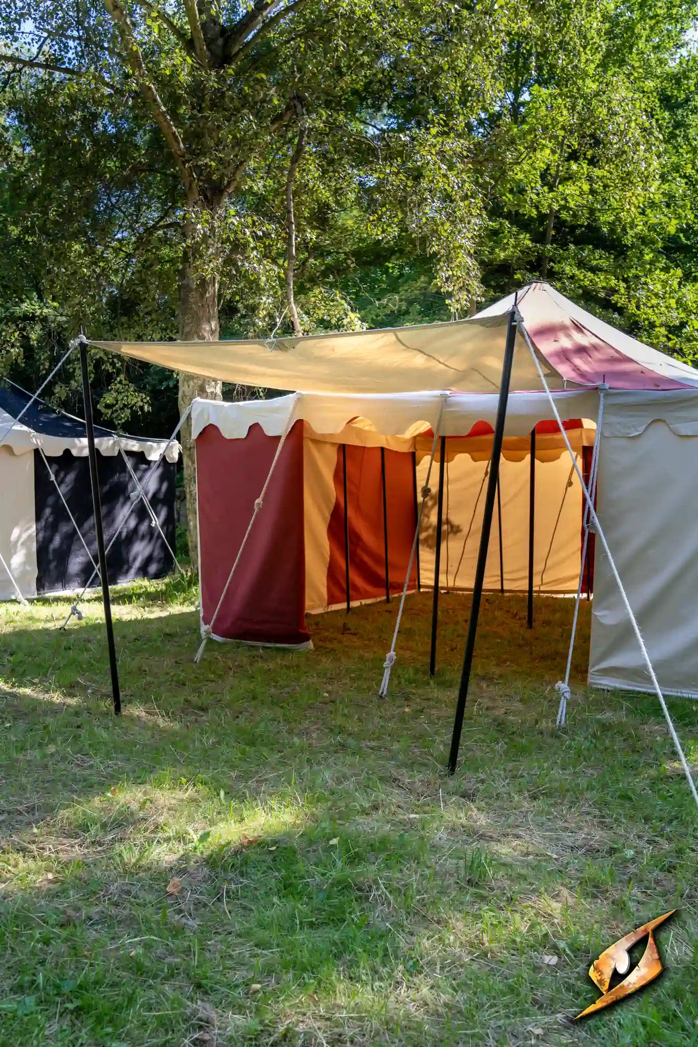 Epic Armoury Tarpaulin set up as a canopy in a camping area with tents.