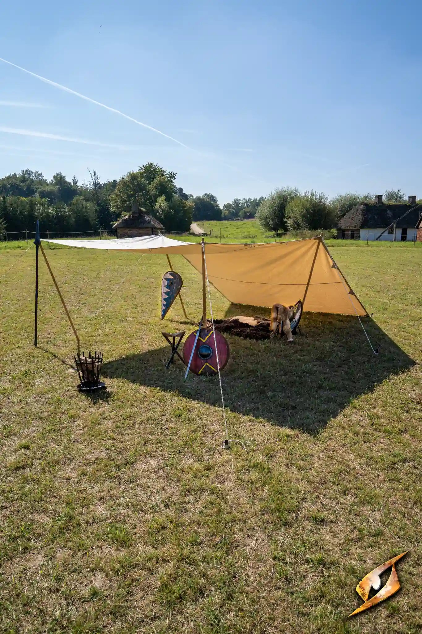 Epic Armoury Tarpaulin set up in an outdoor field for versatile weather protection.