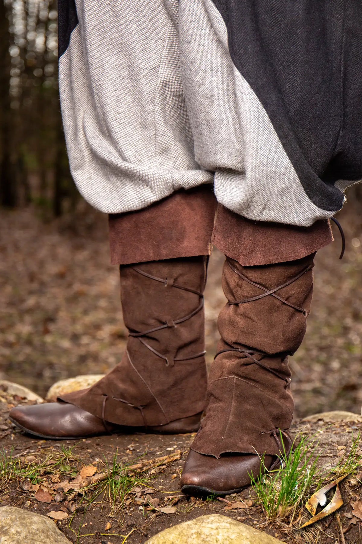 Theoderic gaiters worn outdoors, featuring brown suede and stylish lacing, perfect for muddy streets.