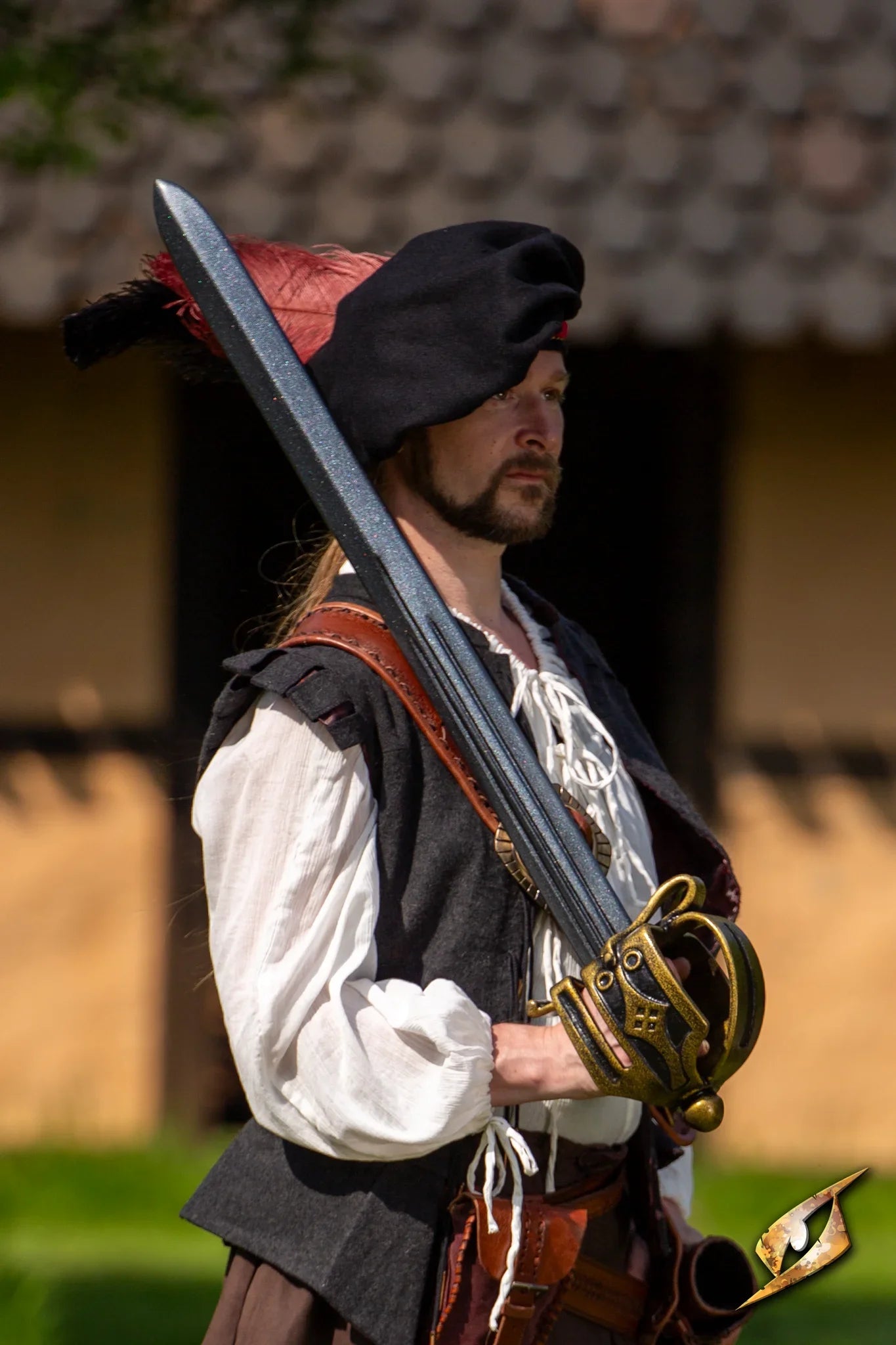 Wool Minstrel Hat worn by a person holding a sword, portraying a historical character outdoors.