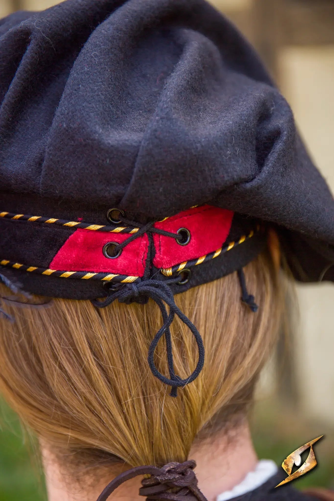Back view of a Wool Minstrel Hat featuring red and black design and laces, ideal for historical reenactments.
