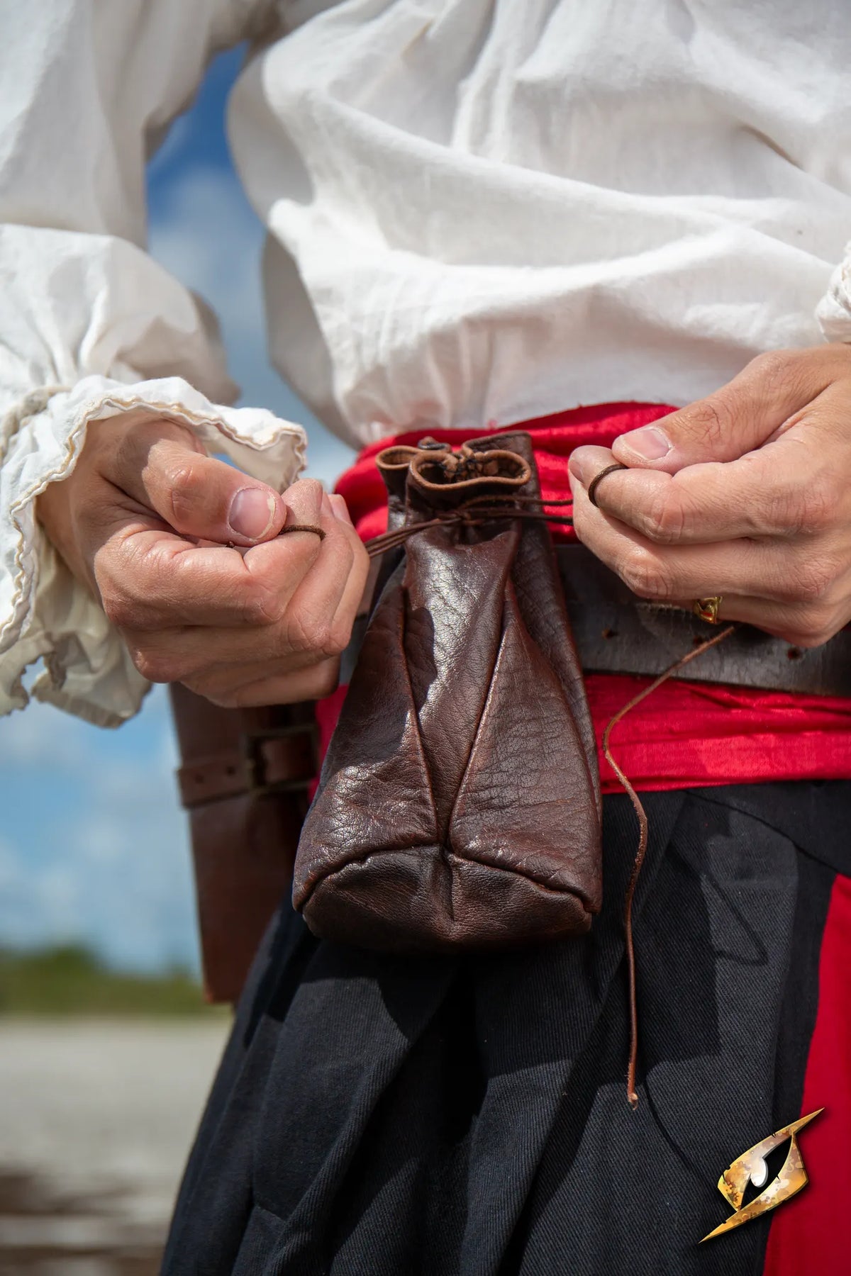 Bounty Hunter Pouch attached to a belt, showcasing its durable leather design and tied with a string.