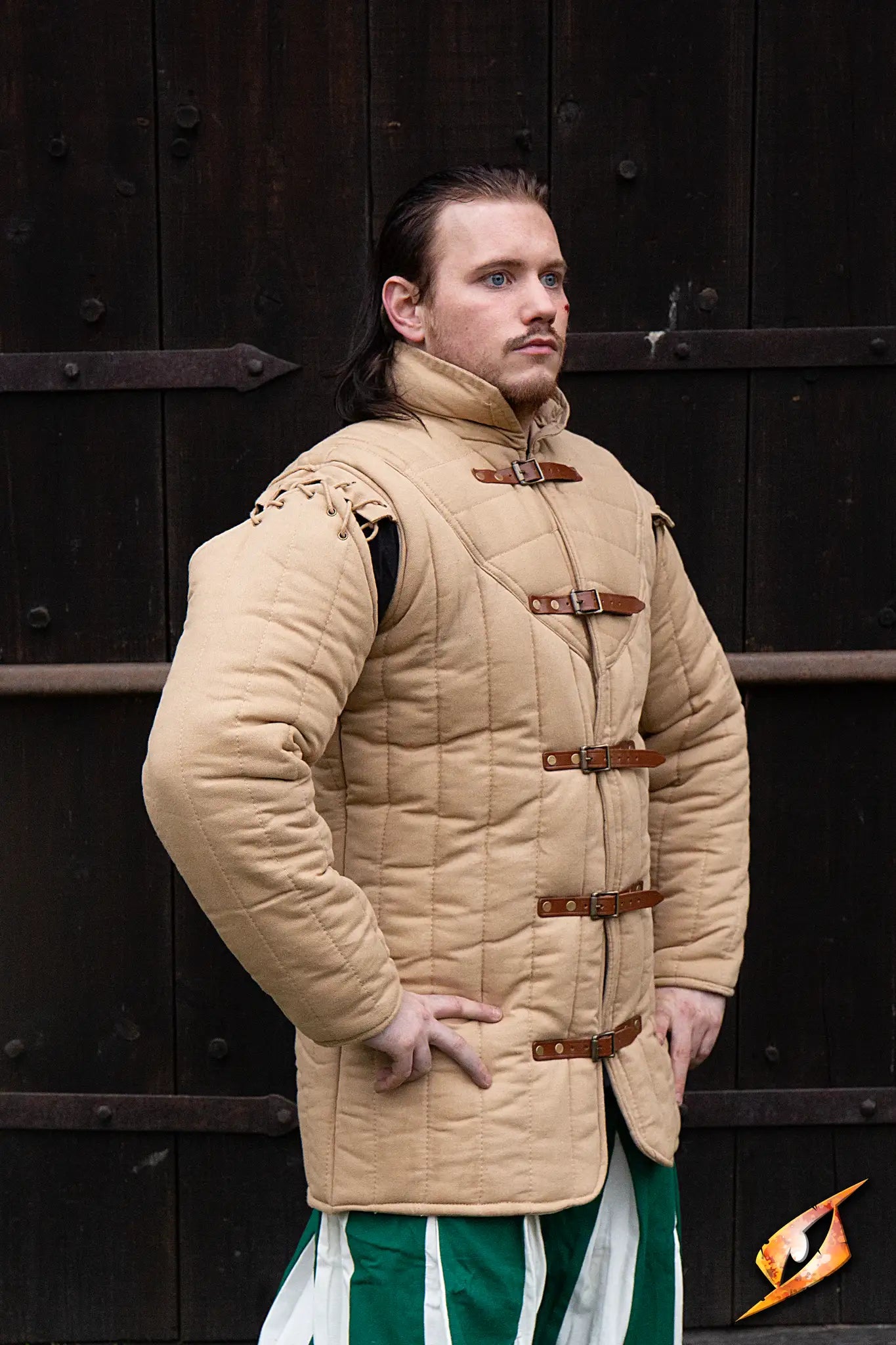 Gambeson Warrior With Long Sleeves worn by a male model standing against a wooden backdrop.