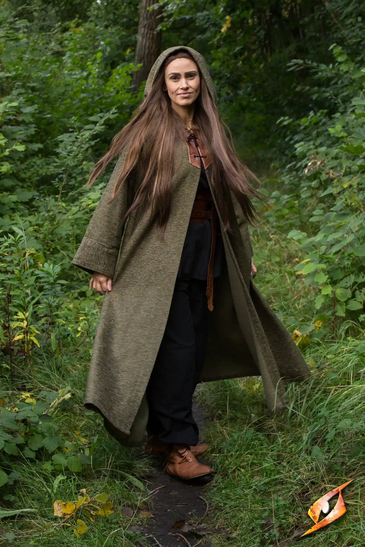Woman in a Robe Benedict walking through nature, showcasing its protective and stylish design.