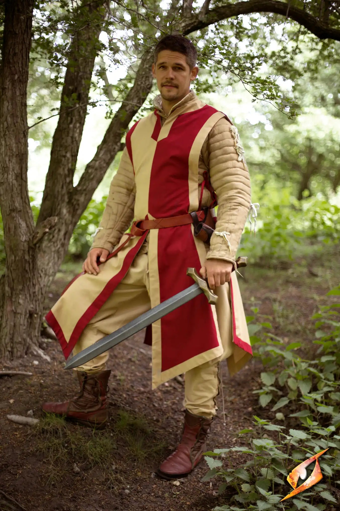 A knight wearing a Basic Tabard with a sword in a wooded area, embodying valor and courage.