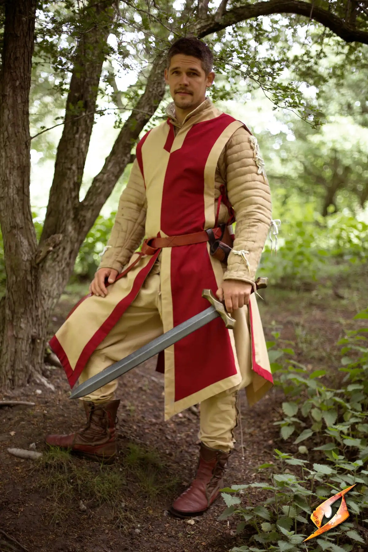 A knight wearing a Basic Tabard with a sword in a wooded area, embodying valor and courage.