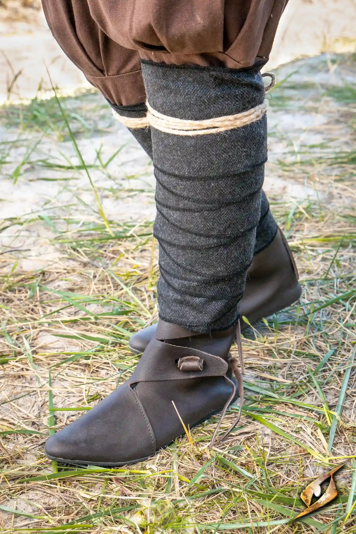 Herringbone Leg Wraps worn with brown shoes on a grassy ground, providing protection in Larp battles.