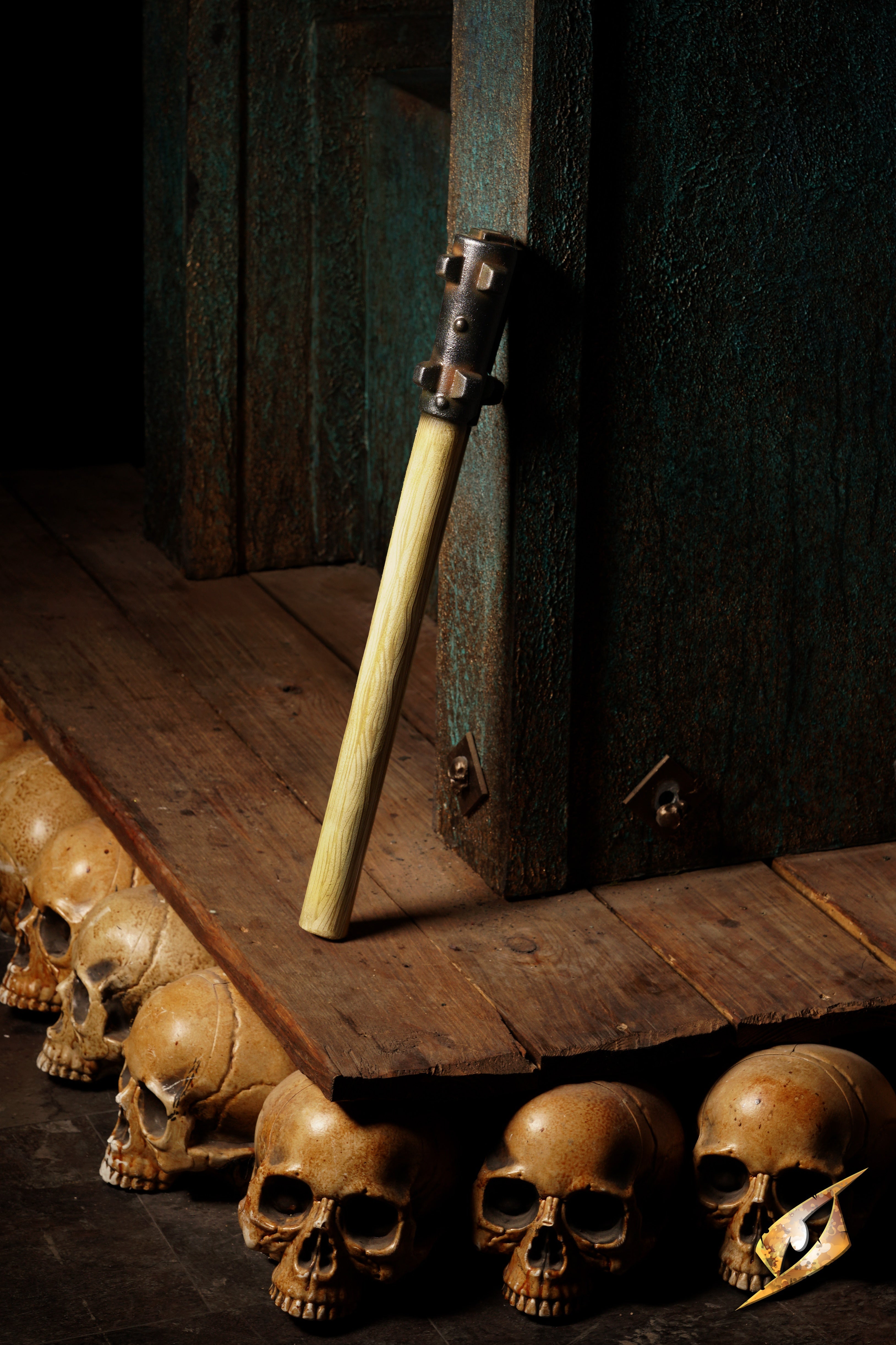 Bommy-Knocker Mace standing next to a row of skulls on a wooden surface, showcasing its fierce design.