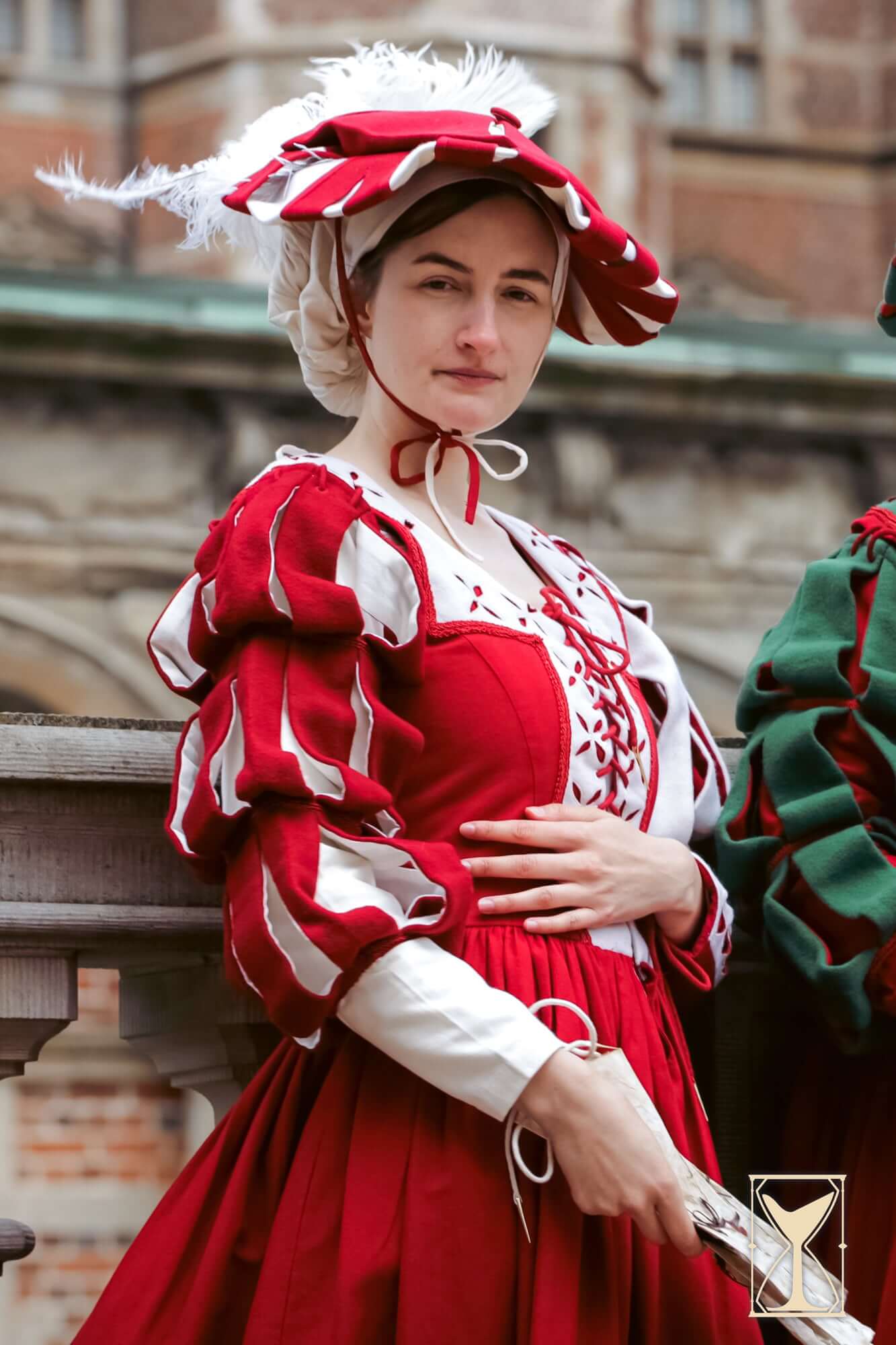 Landsknecht Waterfall Sleeve, a historical costume featuring bold slashed sleeves and luxurious red fabric.