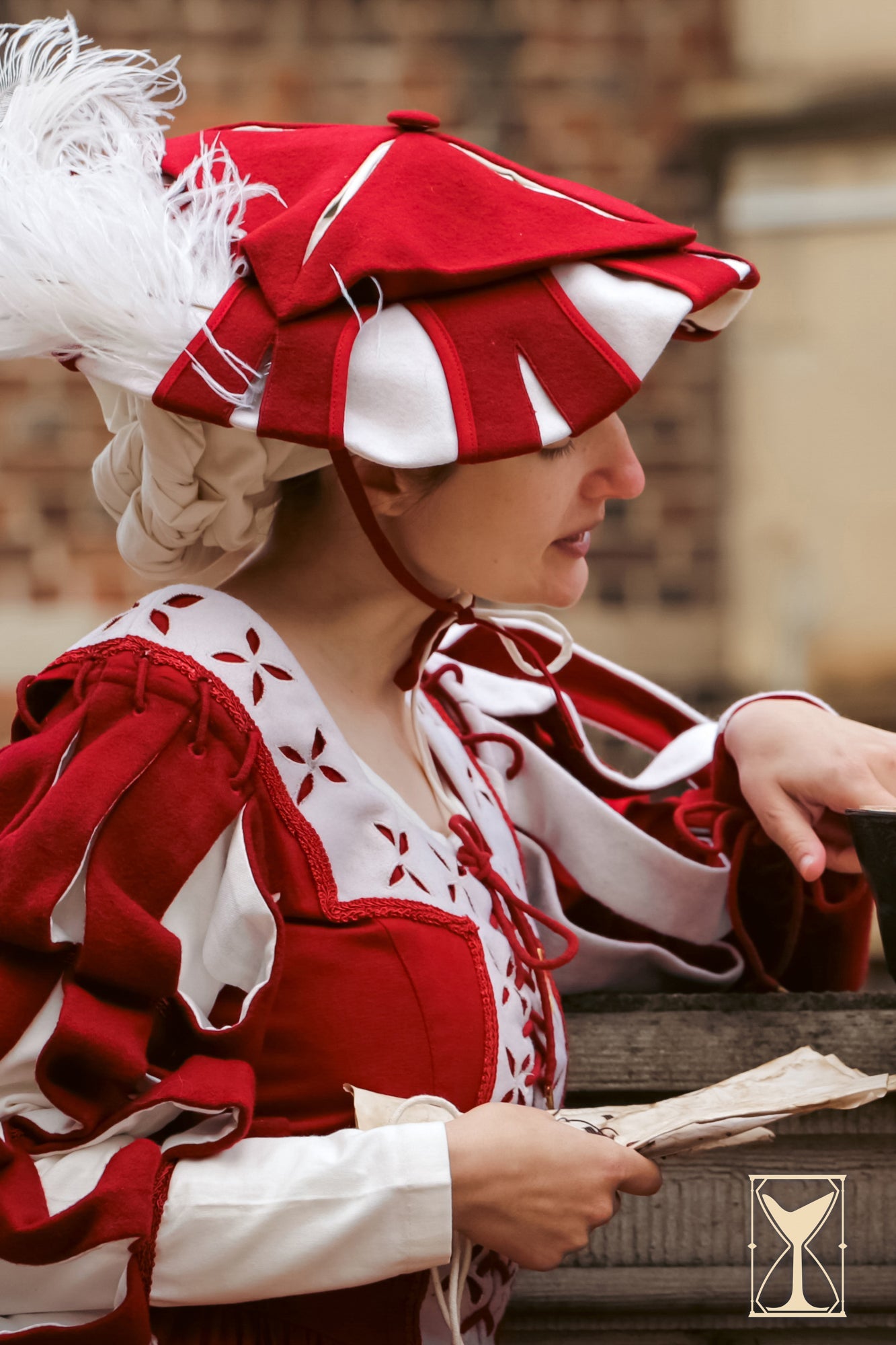 Landsknecht Hat worn by a woman in a historical costume, showcasing bold colors and layered design.