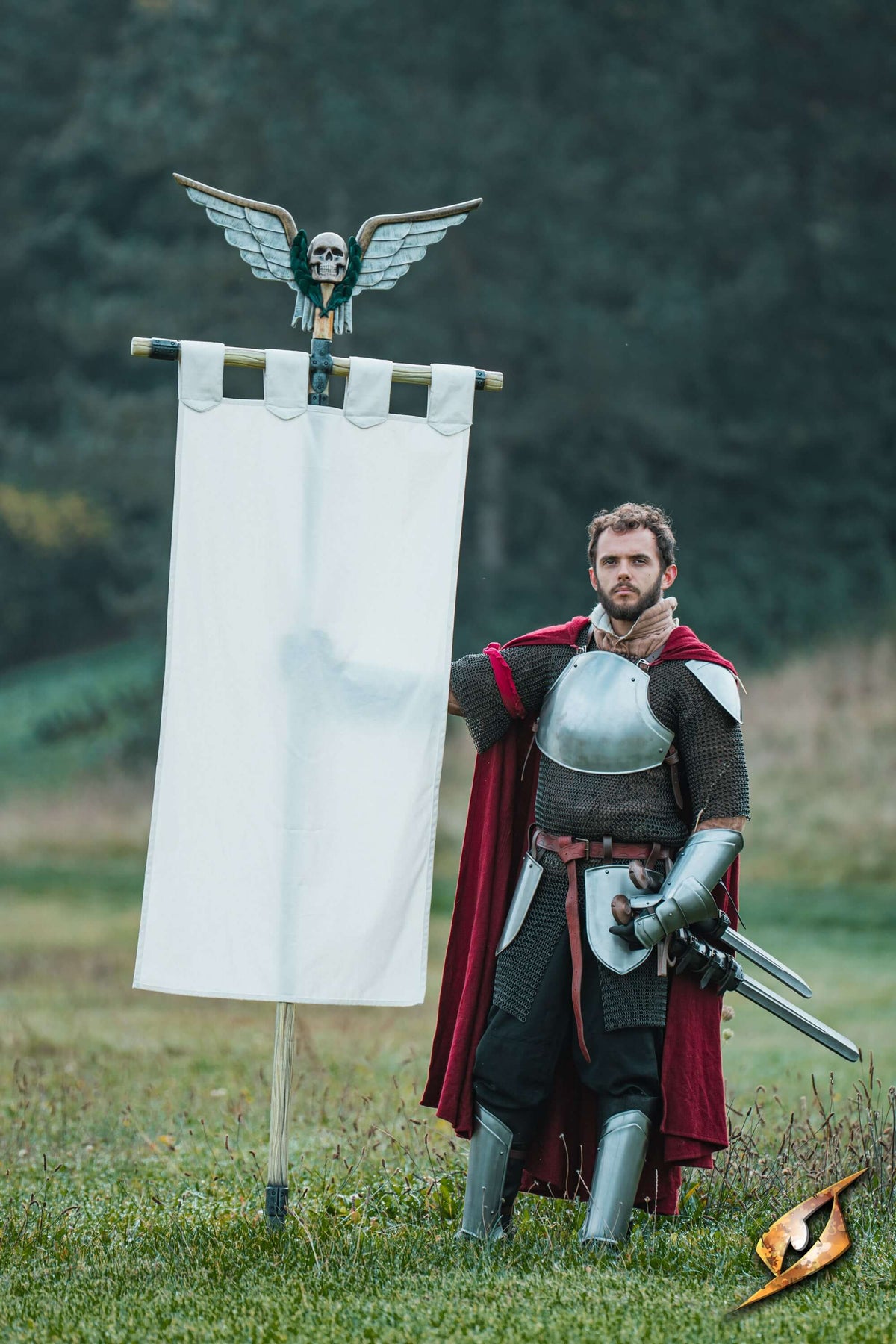 Complete Battle Standard Set - Winged Skull Top with a knight holding a flag in an outdoor setting.