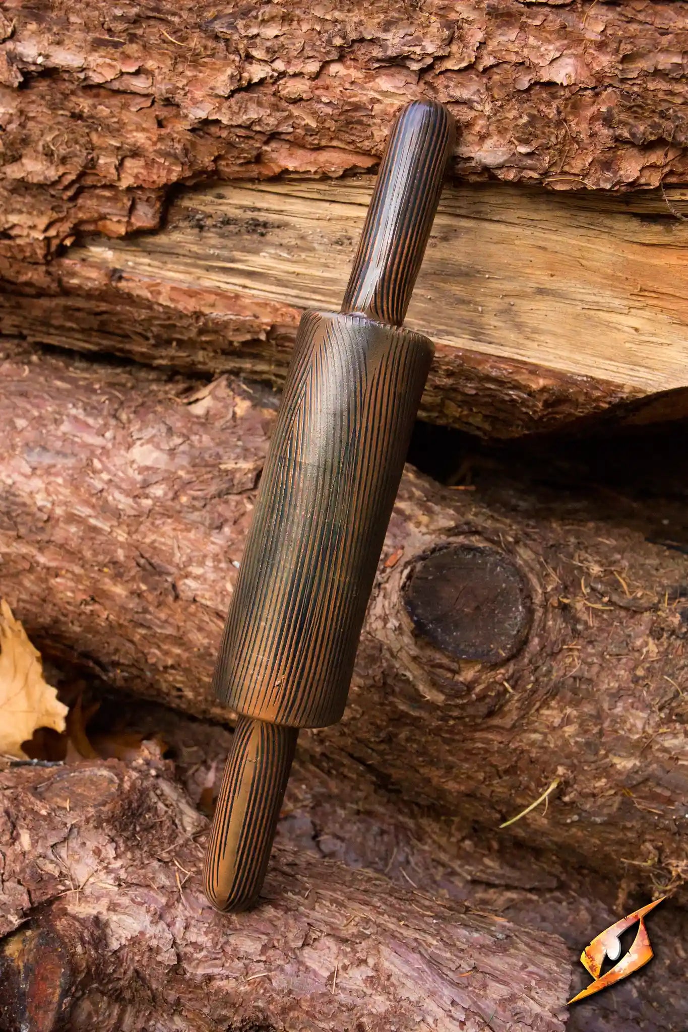 A rustic wooden Rolling Pin resting on logs, perfect for baking and pastry preparation.
