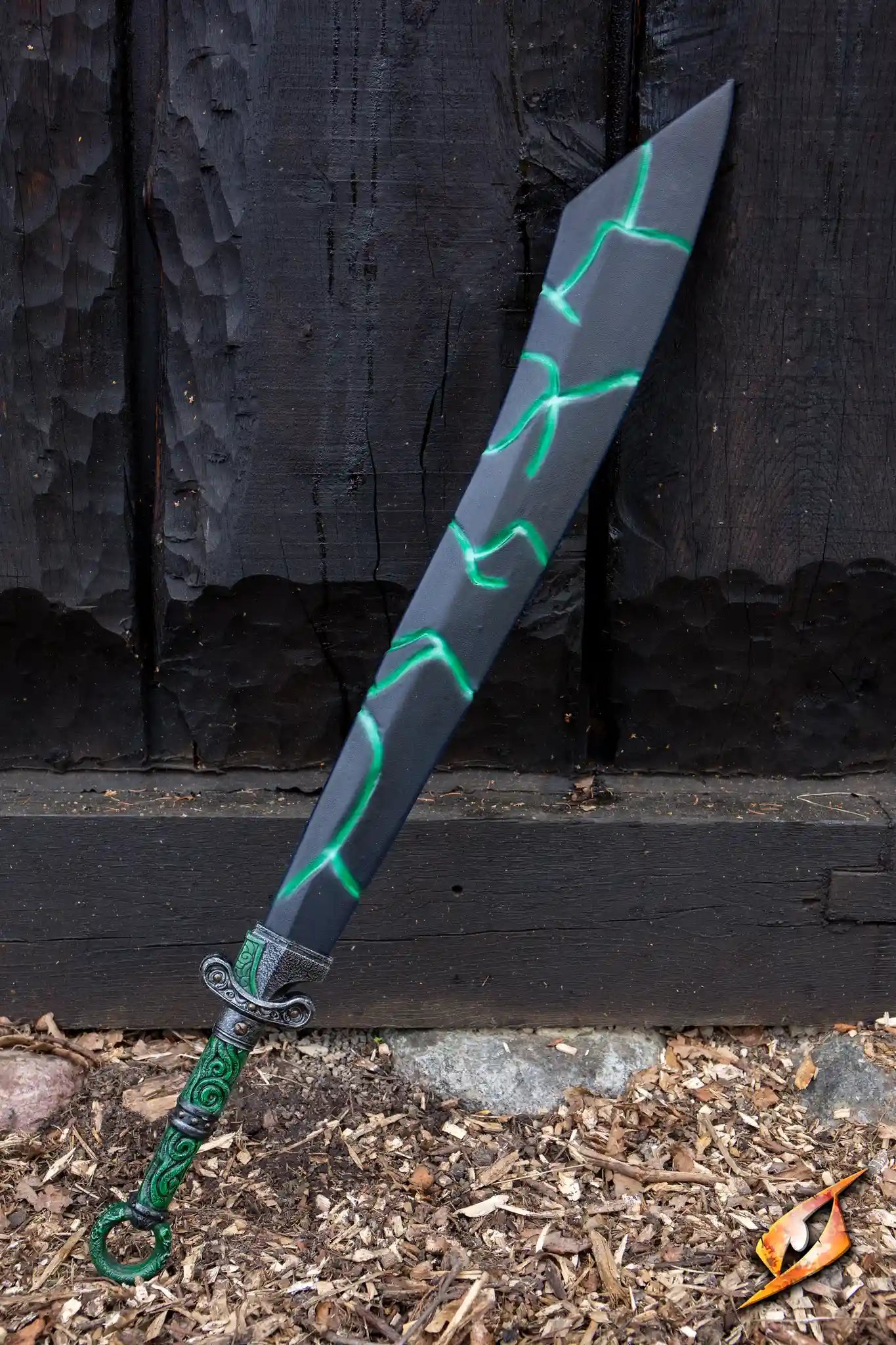 Magic Dao sword with a dark blade and glowing green etchings, resting against a wooden background.