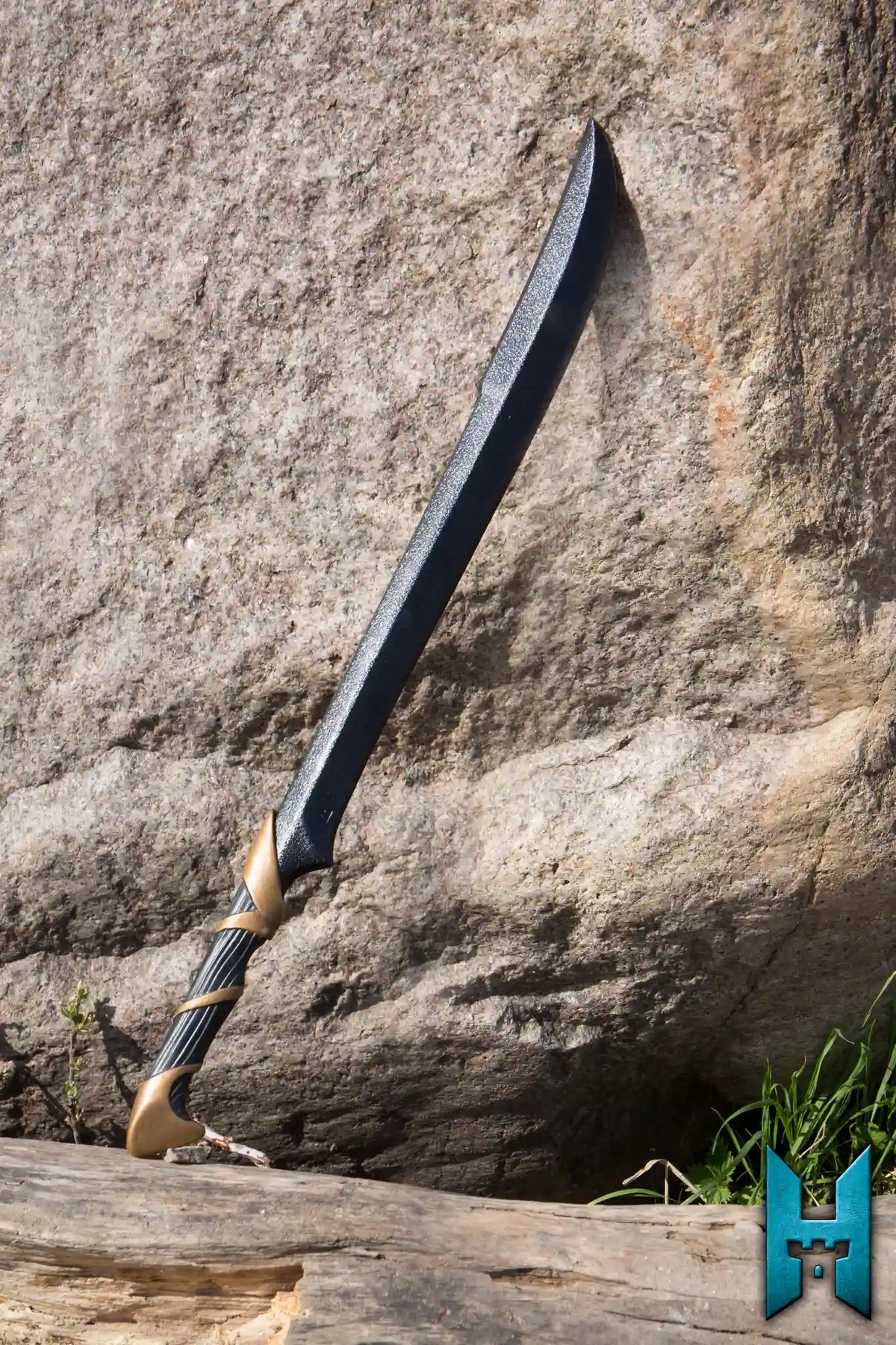 Elven Hunter Blade displayed against a rock, showcasing its finely crafted design and sharp blade.