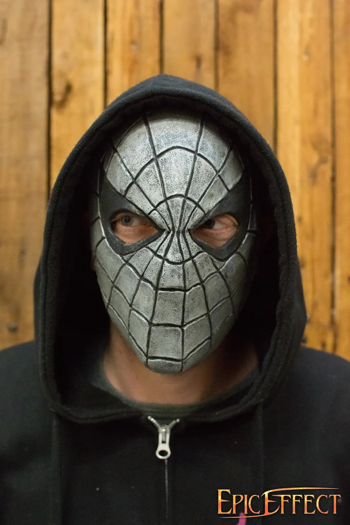 Close-up of Web-Face Trophy Mask worn by a person, featuring a detailed spider web design and hoodie.