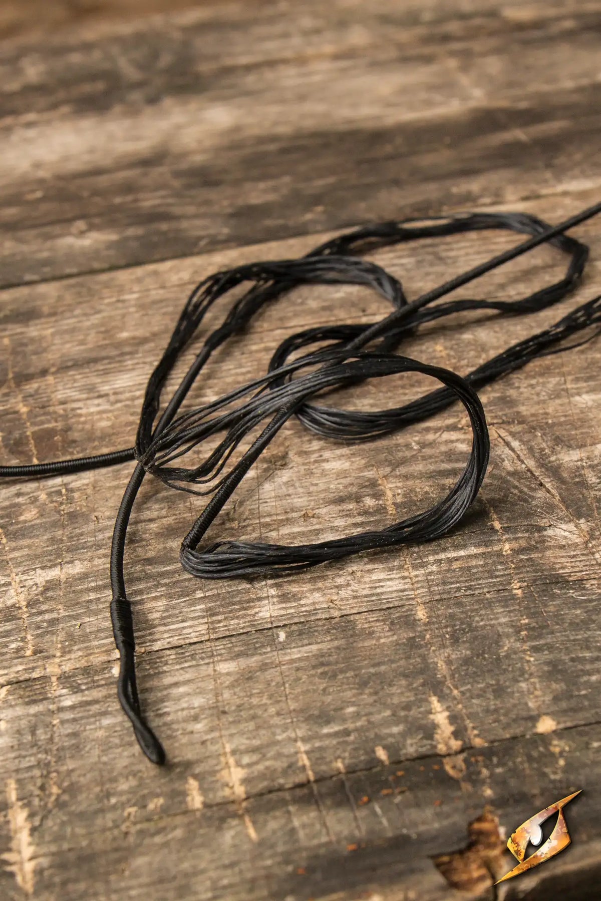 Close-up of Epic Armoury Bow String for Medium LARP Flatbow on wooden surface.