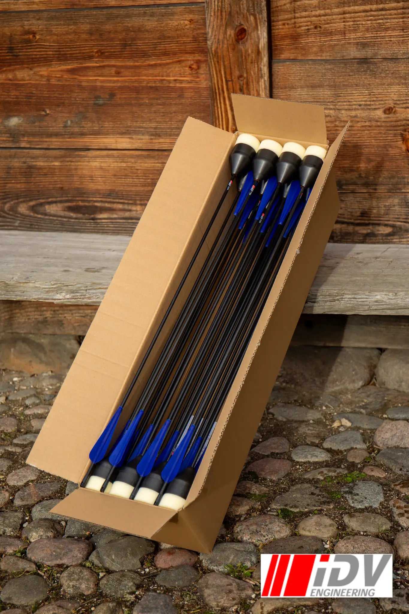 Arrow - Flat Head - Black Shaft inside a cardboard box ready for archery practice.