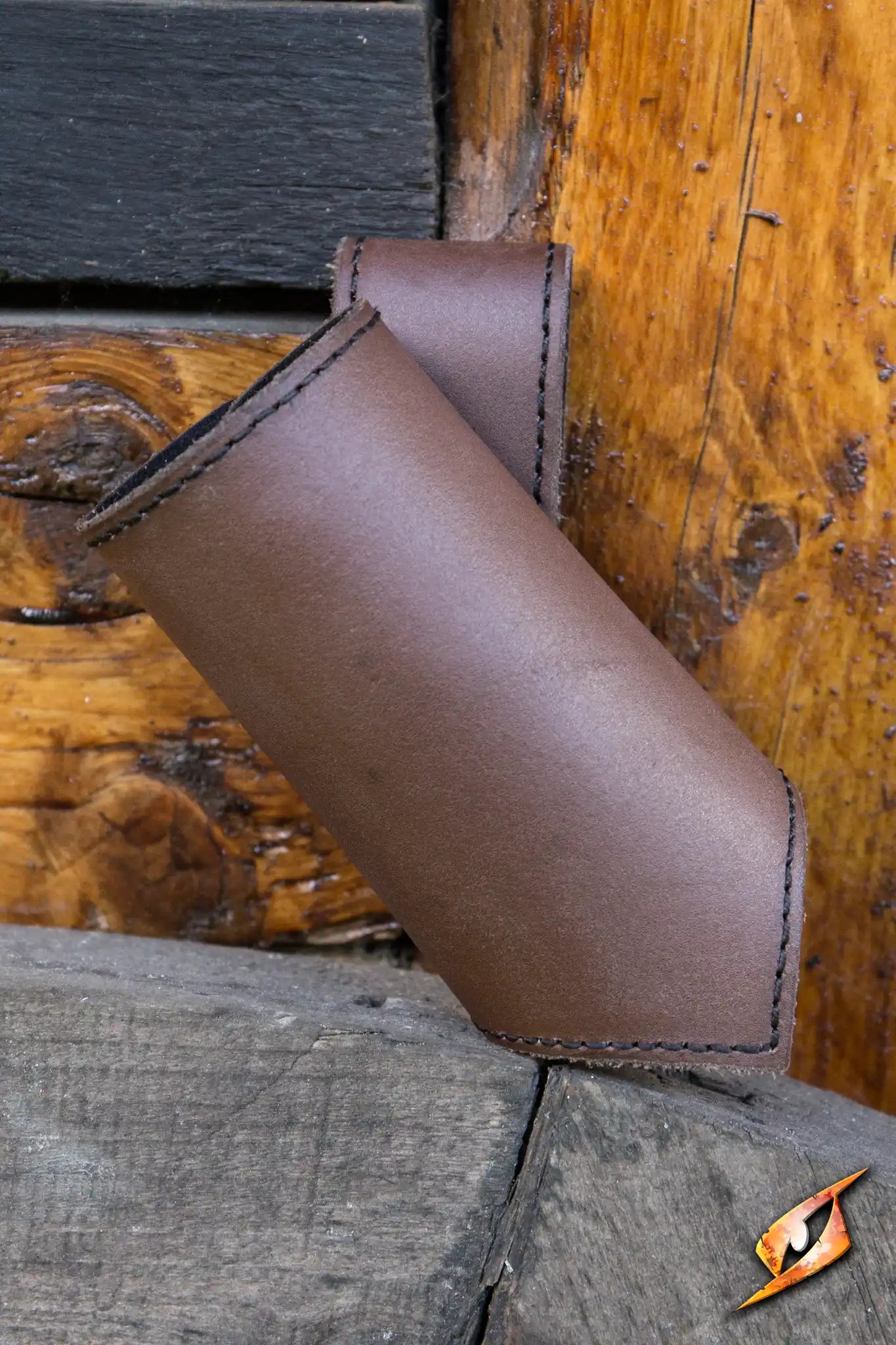 Brown leather Sword Holder secured on wooden surface for adventurers and wanderers.