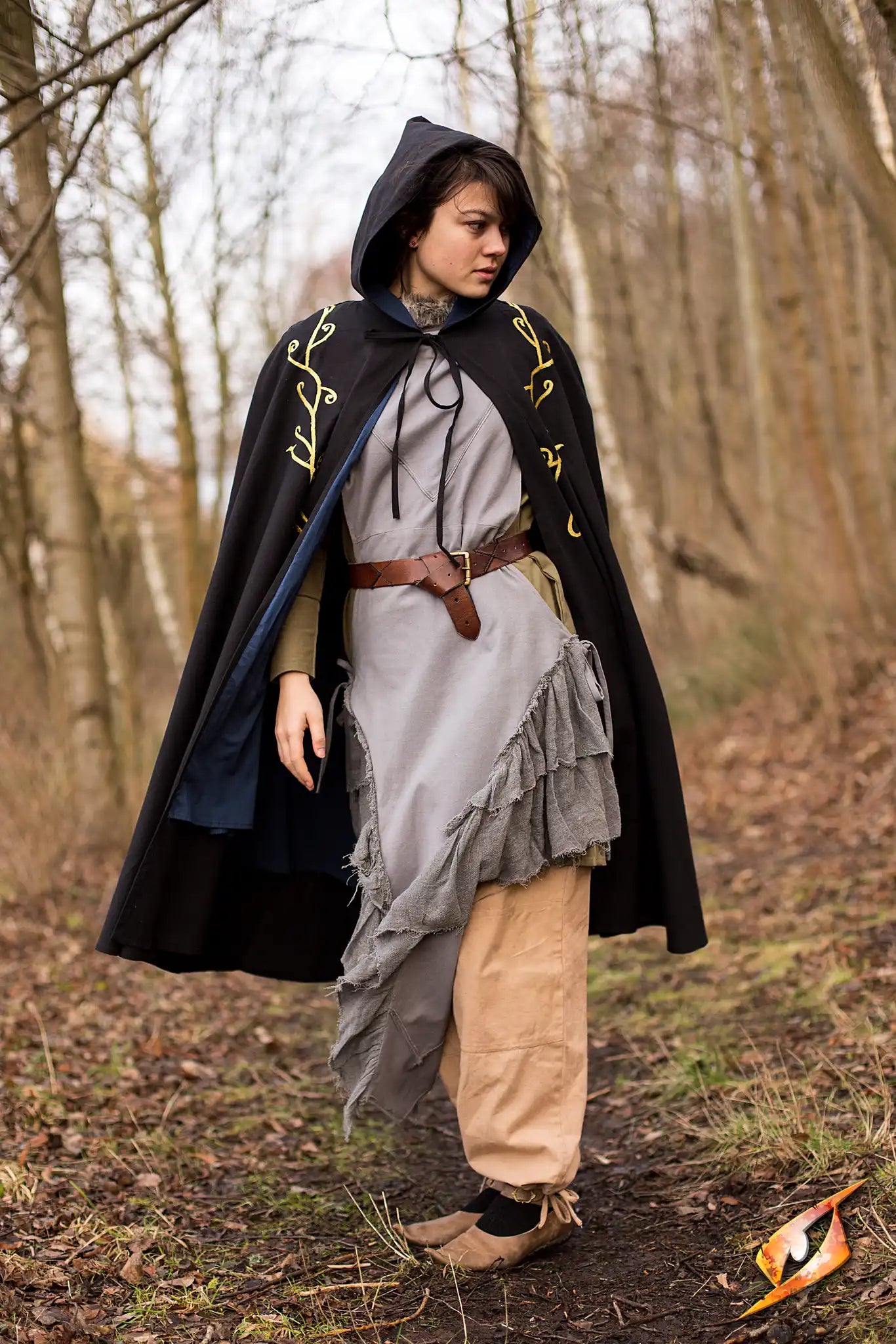 Cape Excl. model wearing the beautifully adorned Epic Armoury’s Cape Exclusive in a forest setting.