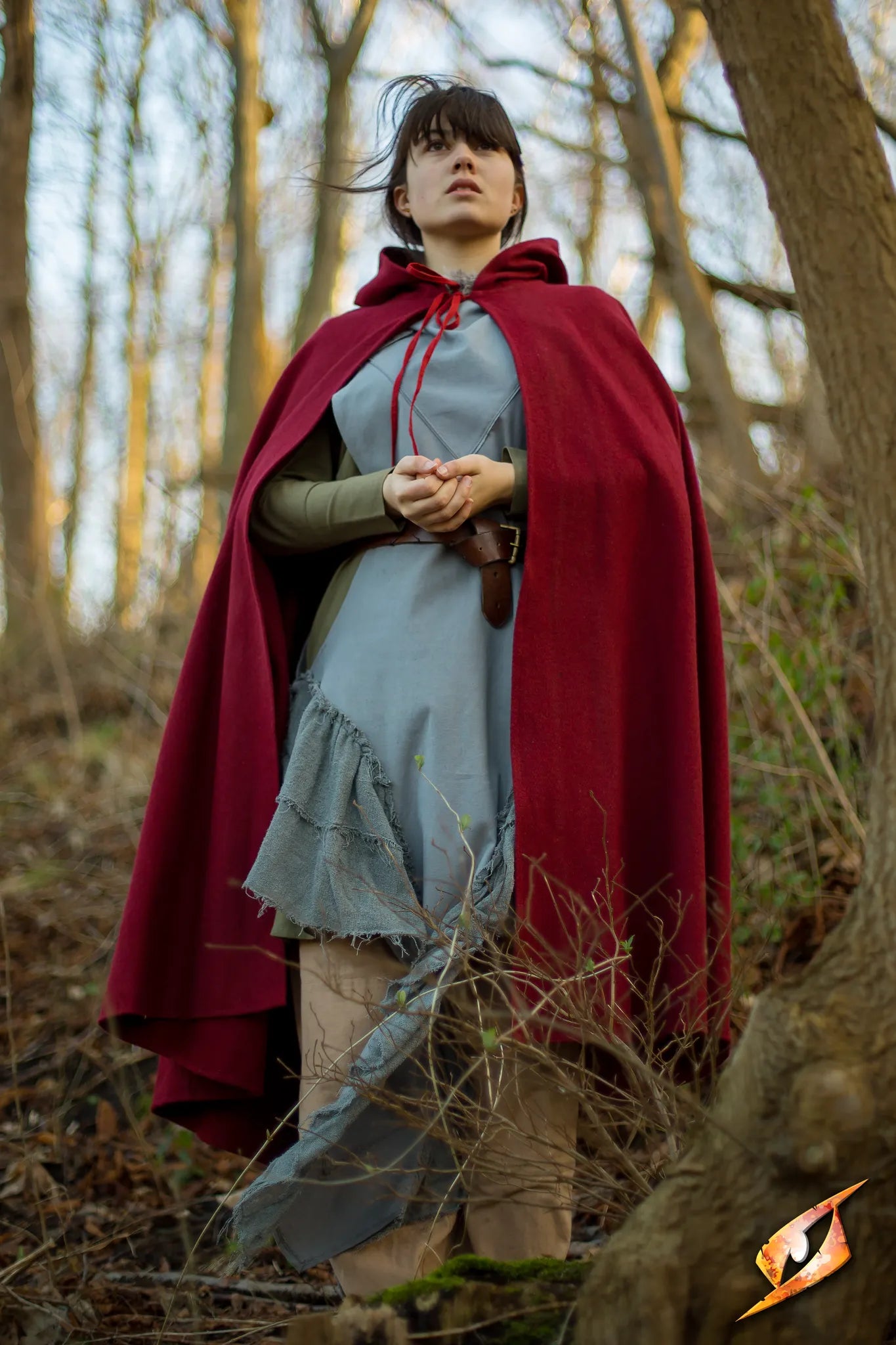 Cape Wool worn by a model in the woods, showcasing a heavy, water-tight design and deep hood.