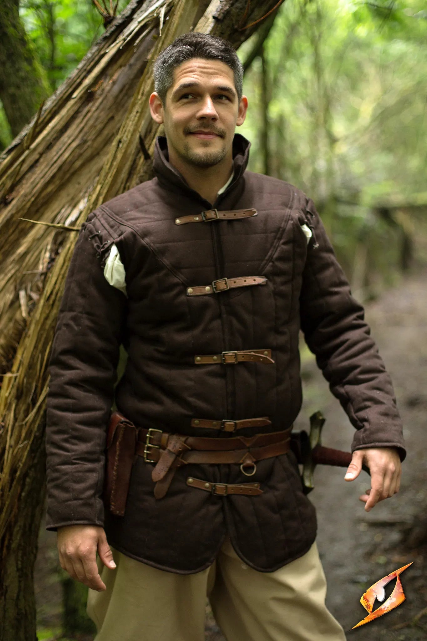 Gambeson Warrior With Long Sleeves model wearing a brown jacket in a forest setting with a confident expression.