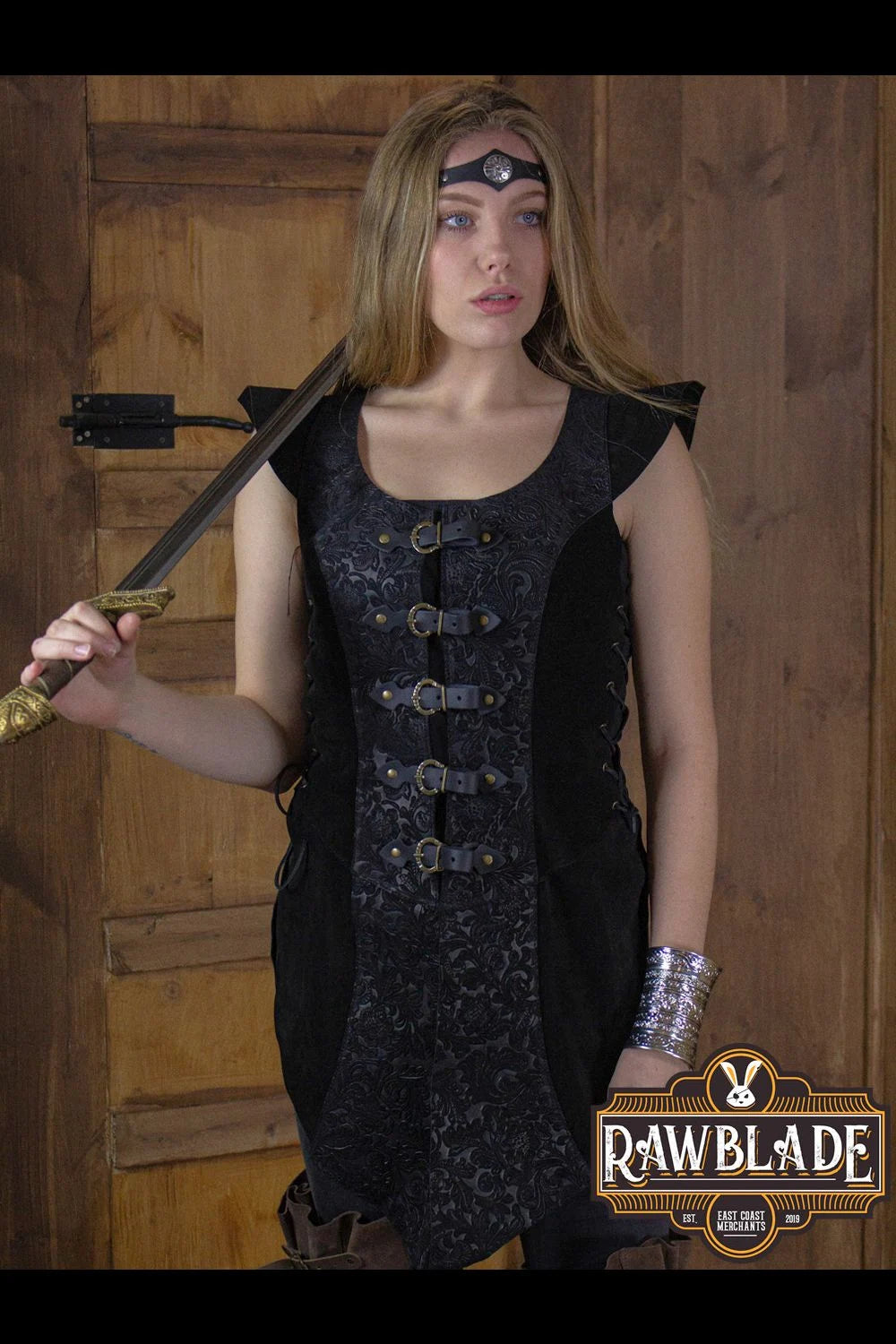 Ylenne Deluxe Long Doublet showcased by a model, featuring embossed leather and hand riveted buckles.