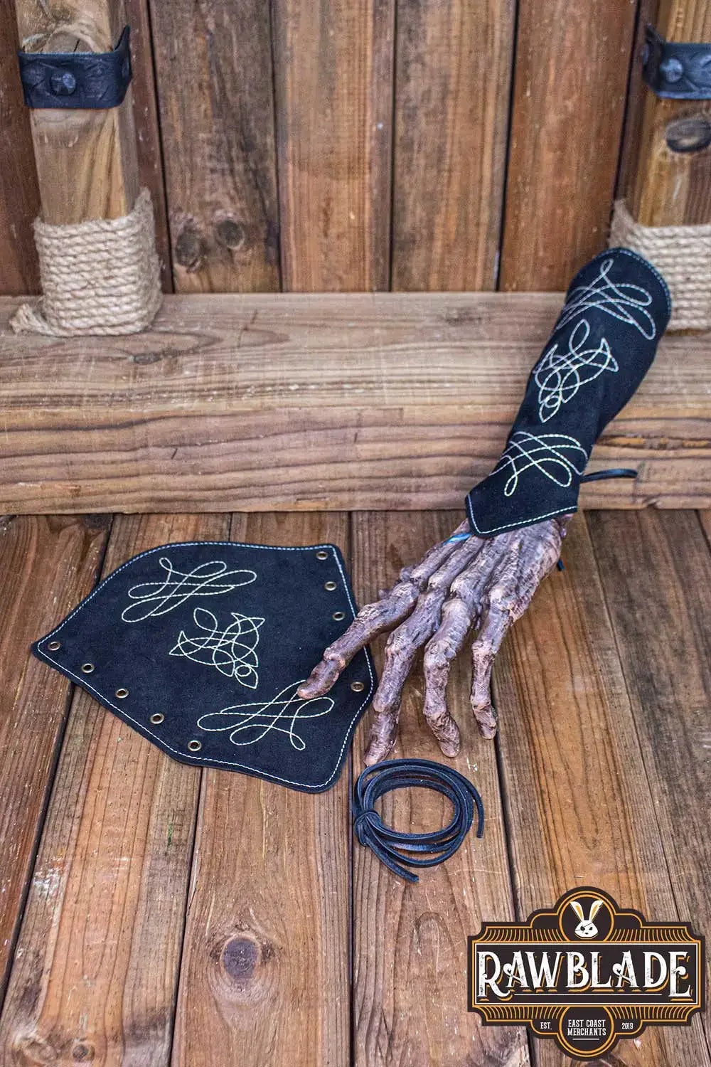 Vryla Premium Bracers displayed on a wooden surface with intricate designs, showcasing elven style craftsmanship.