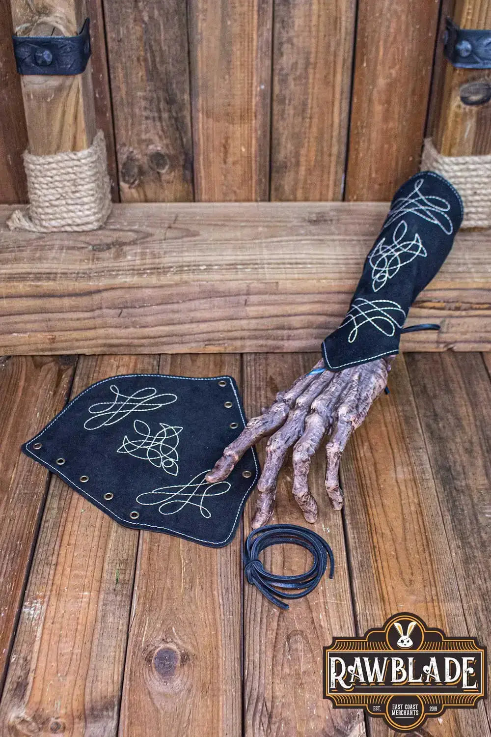 Vryla Premium Bracers displayed on a wooden surface with intricate designs, showcasing elven style craftsmanship.