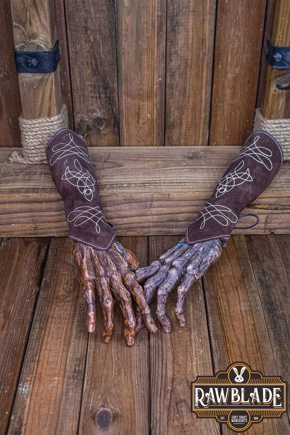 Vryla Premium Bracers displayed on wooden background, showcasing light leather design and elven style.