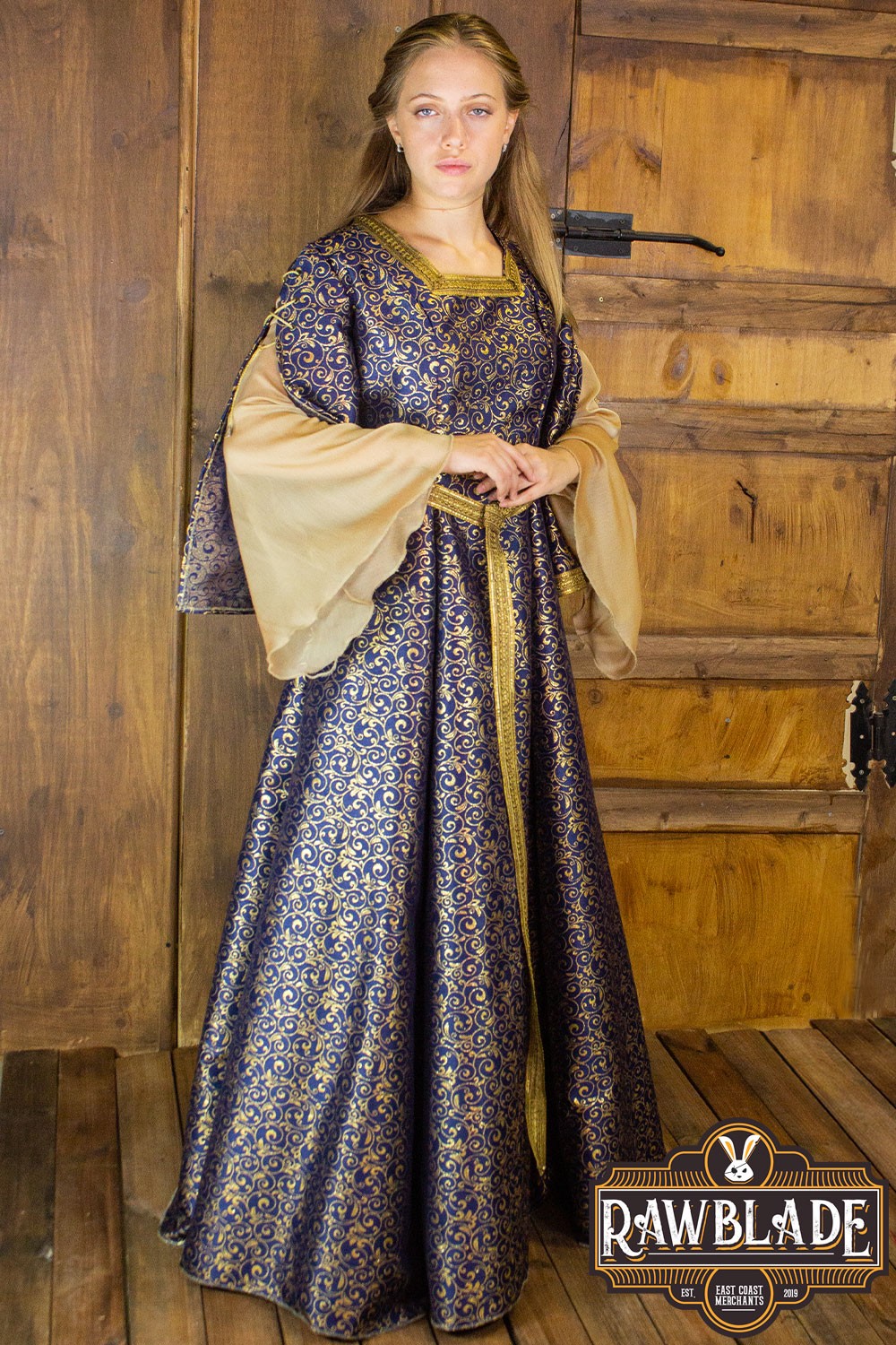 Aquitania Noble Dress featuring gold brocade fabric, double tulle sleeves, and intricate gold trims.