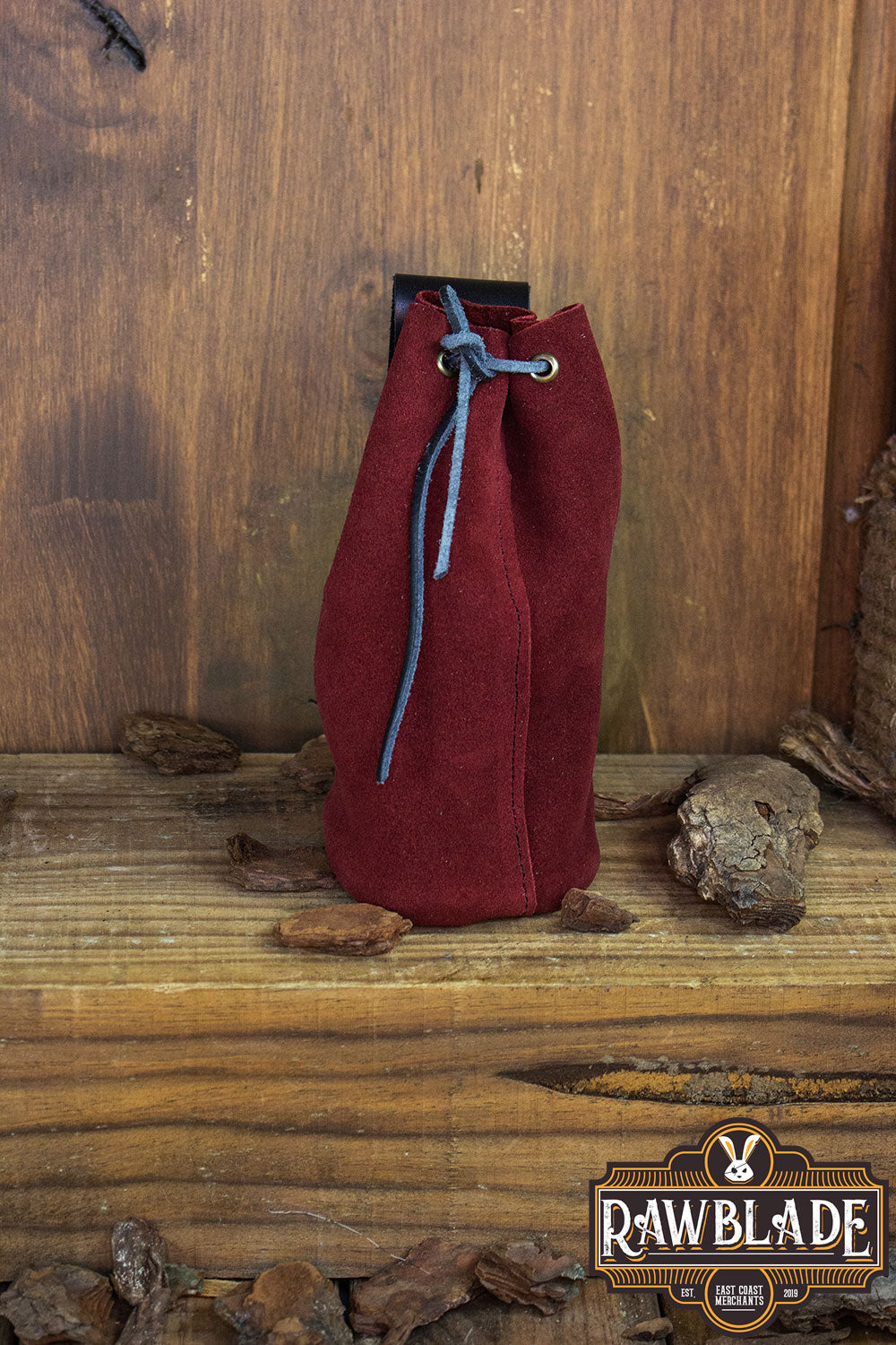 Adventurer Tube Pouch in red suede material, perfect for carrying coins, keys, and magic items.