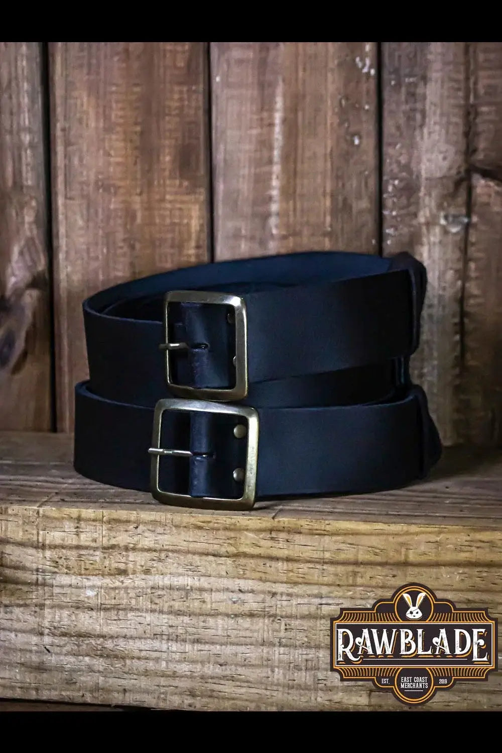 Beligor Double Belt displayed on a wooden surface, showcasing high-quality leather and dual buckles for versatility.